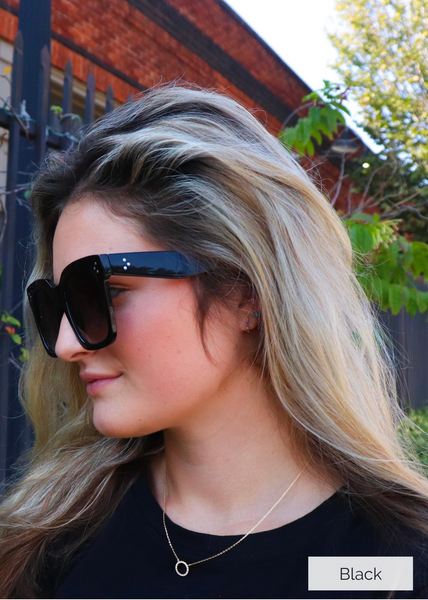 Large framed sunglasses with three dot silver detail on the front and sides of frames